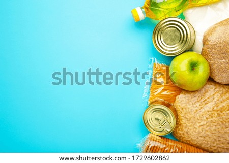 Food donations for people. Flat lay donation food on the blue background. Top view. Coronavirus