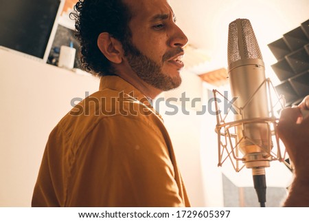 Moroccan man recording vocals in studio