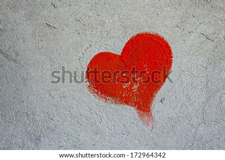 Red painted heart on a concrete wall