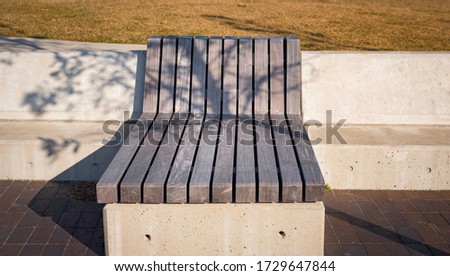 Large wooden bench on the riverbank park in East Boston
