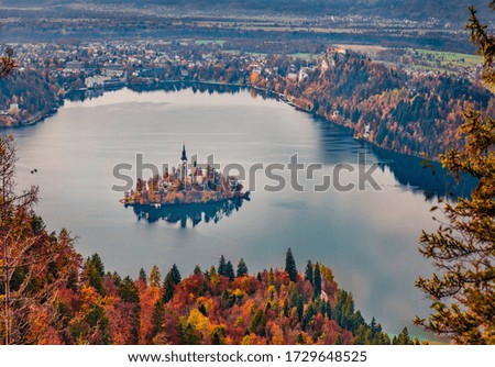 Aerial morning scene of church of Assumption of Maria. Scenic autumn view of Bled lake. Calm autumn landscape of Julian Alps, Slovenia, Europe. Traveling concept background.