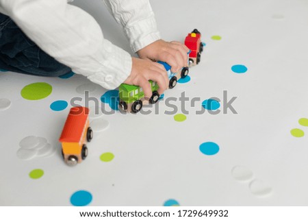 a little boy plays with a train. the child's birthday. decorations balloons and flags