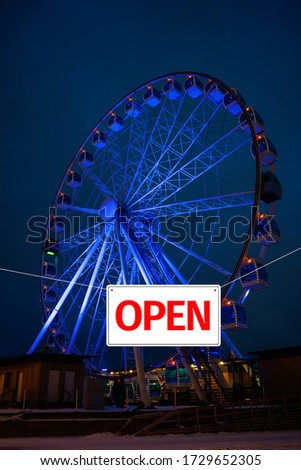 It is open again. Out of isolation due to pandemic. Passage to ferris wheel is open. Concept of opening public places.