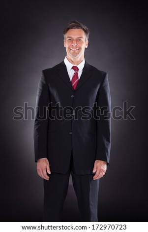 Portrait Of Happy Mature Businessman Isolated Over Black Background