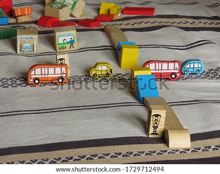 Children's game, figures of different colors and shapes with the inscriptions "Station", "Hotel", "Cashier", "Car wash", "Car service", "Gasoline". Selective focus picture.                     
