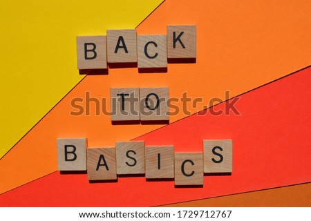Back to Basics in 3d wooden alphabet letters  isolated on orange and red background