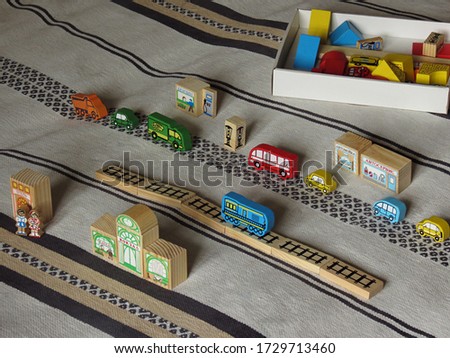 Children's  game, figures of different colors and shapes with the inscriptions "Station", "Hotel", "Cashier", "Car wash", "Car service", "Gasoline". Selective focus picture                           