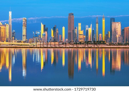 View on Dubai skyline with reflection in the river at sunrise, Dubai, United Arab Emirates 