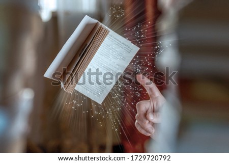 Magic book and male hand. Male magician with spell book