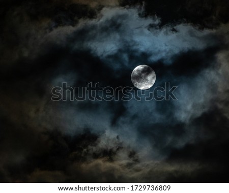 Eerie, super moon on a cloudy night in Texas