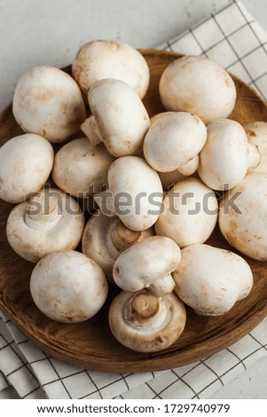 Fresh porcini mushrooms on a wooden plate close-up. Food for vegetarians. copy space. Ingredients