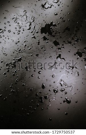 black table in drops of water