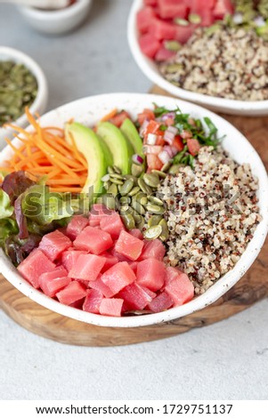 Healthy raw tuna bowl with quinoa and vegetales. Buddha bowl.