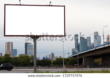 Billboard on the background of the city and the bridge. Mock-up.