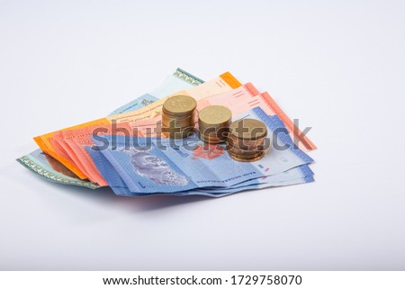 Stack Malaysia Bank note with coin on White Background.