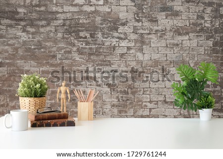 Mockup workspace desk and copy space books,plant and coffee on wood desk. Royalty-Free Stock Photo #1729761244