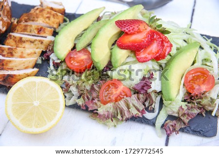 A picture of avocado salad with strawberry.