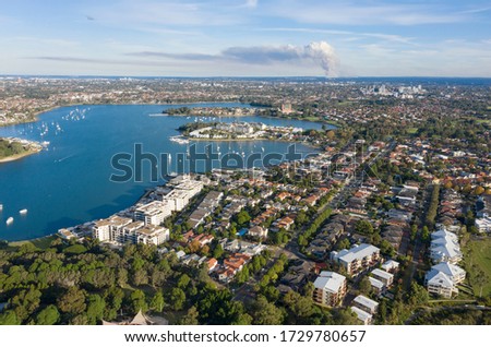 The Sydney suburb of Canada Bay and  hen and chicken bay with back burning bush fire smoke coming from the Royal National Park in the South.