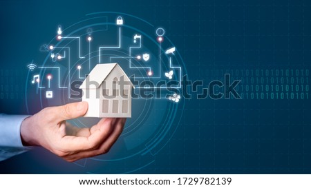 Assistant Smart home automation futuristic interface on virtual screen. Man's hand holding small house. Automation system technology of things