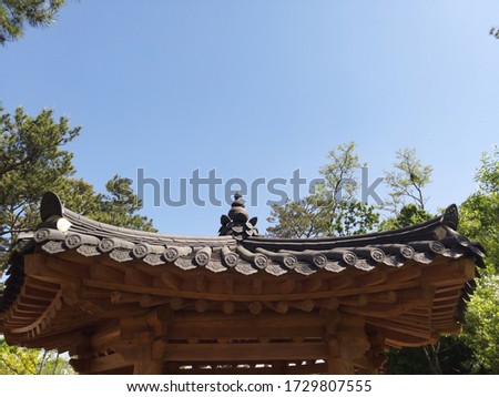 korean style roofing roof and blue sky and pine tree Royalty-Free Stock Photo #1729807555