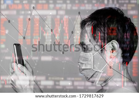 Asian man use smart phone invest in Stock market during quarantine, surge and dramatically fall down as a result of Coronavirus or covid19 fears and world oil  price decrease during countries lockdown Royalty-Free Stock Photo #1729817629