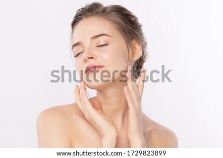 Beautiful Young Woman touching her clean face with fresh Healthy Skin, isolated on white background, Beauty Cosmetics and Facial treatment Concept
