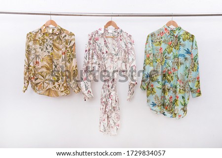 women's sundress dress with floral .palm pattern and floral .palm pattern blouse,shirt on hanger
