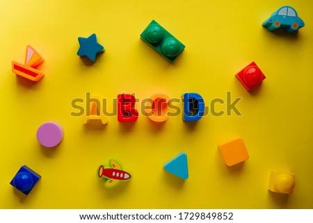 children's letters abcd on a yellow background top view