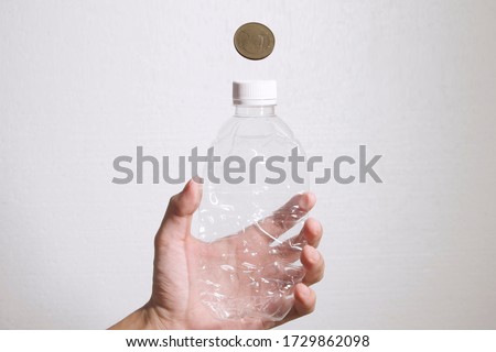 Transfer Plastic Bottle to coin or money. Recycle plastic bottle to money. Concept for recycle and make money with plastic bottle. New way of making money