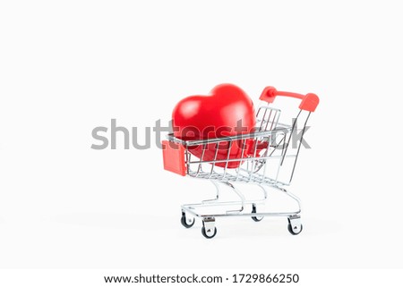 health care concept,a plastic red heart in a shopping cart with copy space isolated on white background,selective focus