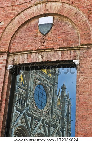 Reflection of the facade of the Dome of Siena, Siena, Tuscany, Italy