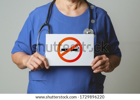 Quit smoking, no tobacco day, doctor holding no smoking sign