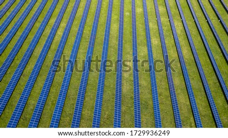 aerial view of solar panels on green lawn. drone shot, bird's eye