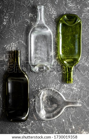 Pattern of bottles on grey table top-down