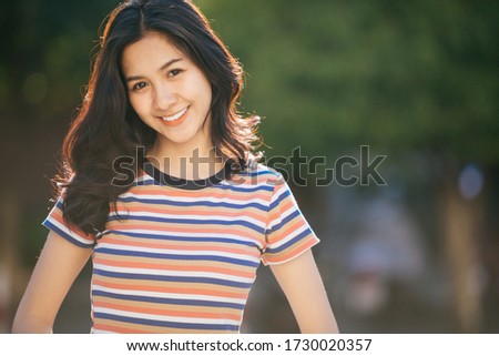 Young beautiful woman smiling happy walking on city streets on a sunny day of summer