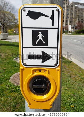 Yellow Crosswalk button with street view background