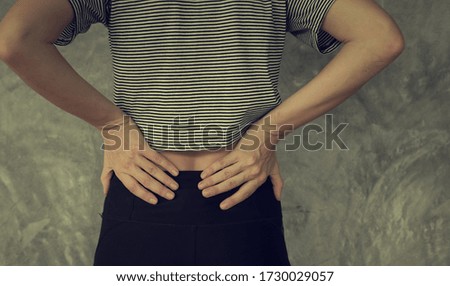 Woman touching his back for the pain