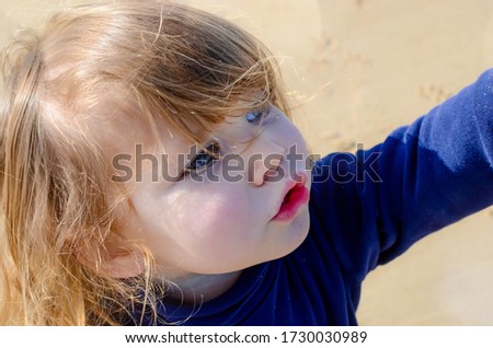 pretty little girl enjoying the beach