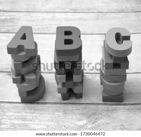  photo of a wooden alphabet blocks spelling abc. Wooden cubes with letter A B C isolated on blue wooden  background.
