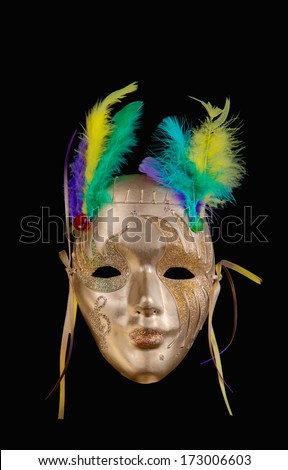Golden Mardi Gras mask on dark background
