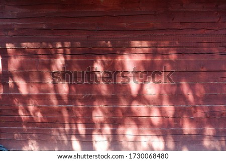 
wooden red boards background with glare of sunlight