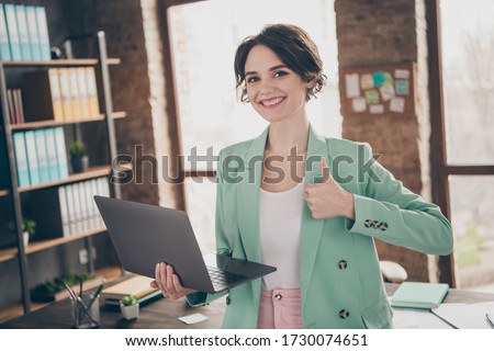 Photo of beautiful business lady hold notebook chatting colleagues raise thumb finger up insurance agent home remote work wear blazer near table modern interior home office indoors Royalty-Free Stock Photo #1730074651