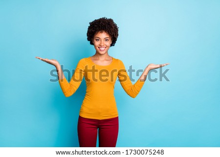 Portrait of her she nice attractive lovely confident cheerful cheery wavy-haired girl holding on two palms copy space pros cons isolated over bright vivid shine vibrant blue color background