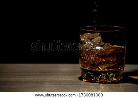 Pouring whiskey into a glass