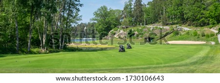 Out of focus photo. Blurred picture of long green golf course at spring 2020. Special equipment carts. Nobody is playing during coronavirus covid 19 epidemic. Header. Banner. 