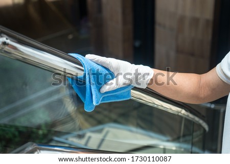 Deep cleaning for Covid-19 (corona virus) disease prevention. For safety, spray alcohol, disinfectant on the cleaning cloth wipes in places that are frequently touched at the hotel.  Royalty-Free Stock Photo #1730110087