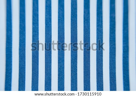 Close-up of decorative fabric in blue and white stripes 