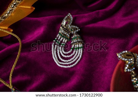 earring with pearls on purple velvet cloth elegant 