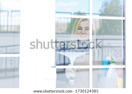 Beautiful woman in protective gloves cleaning office