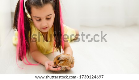 My little pal - girl holding her hamster in palms Royalty-Free Stock Photo #1730124697